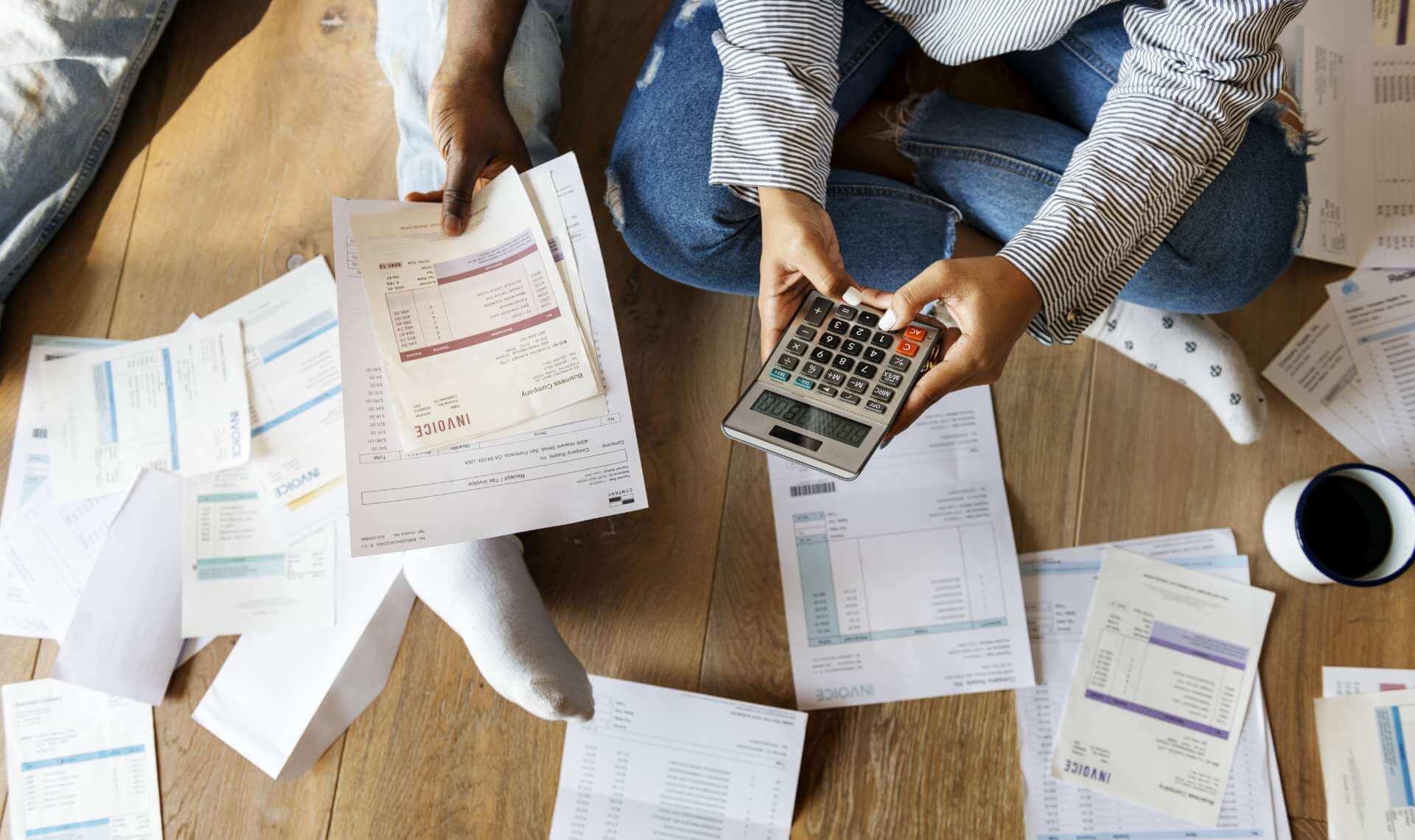 People organizing ther finances with calculators and papers